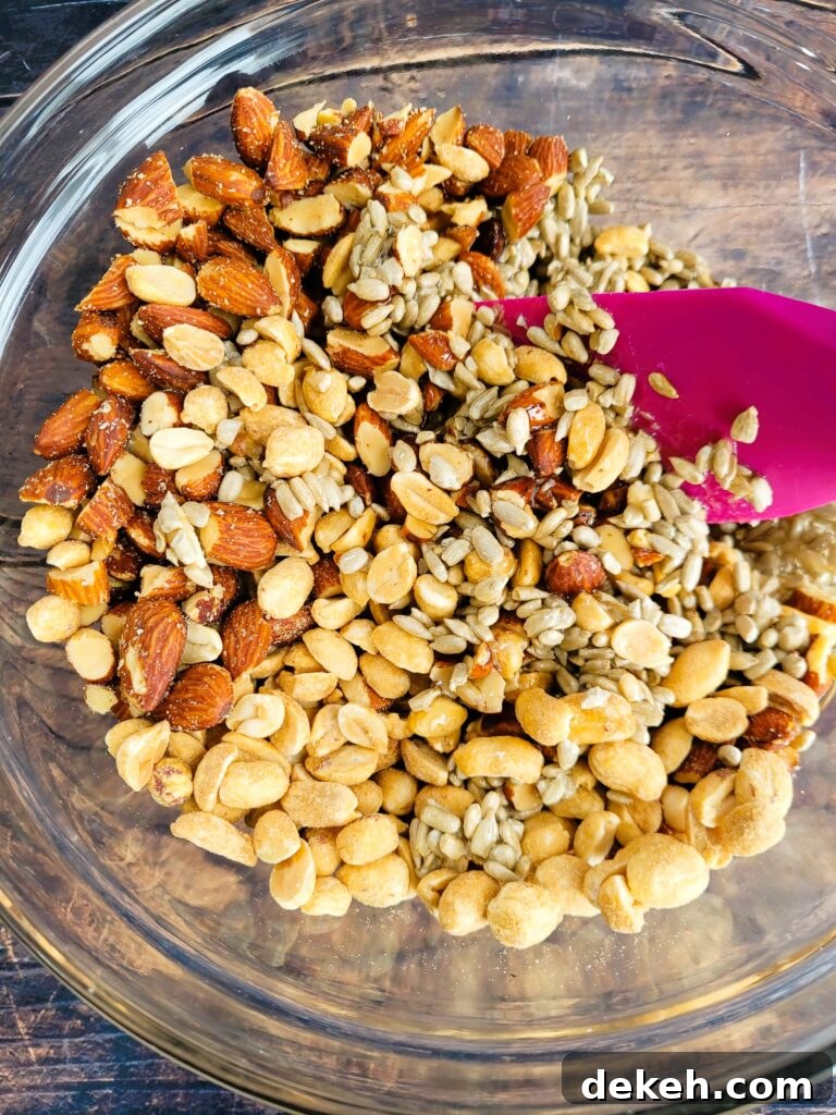 Crunchy Homemade Nut Bars: Step-by-Step Recipe 6 Mixing roasted almonds, peanuts, and sunflower seeds into syrup mixture for nut bars
