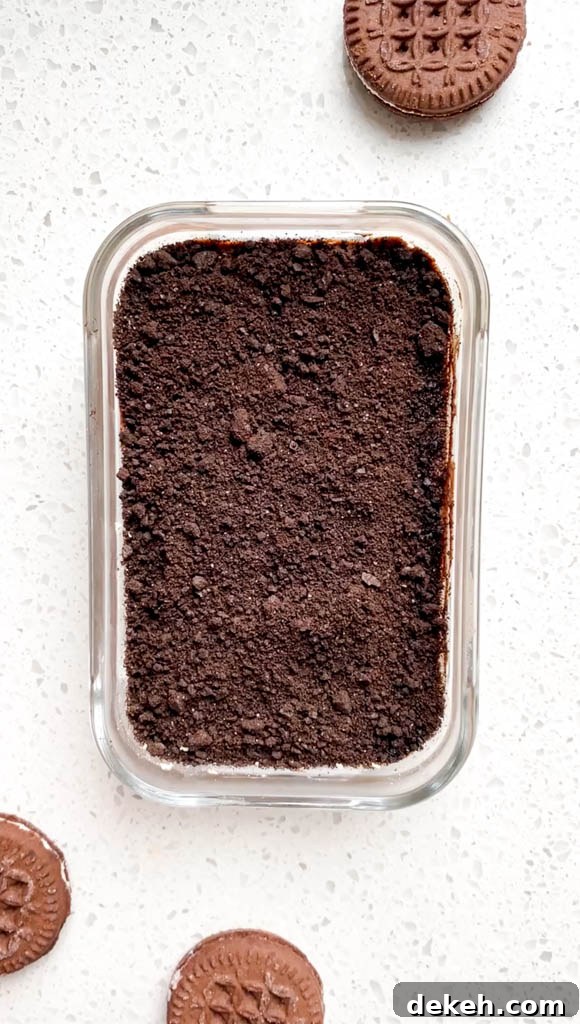 Oreo Protein Overnight Oats Recipe: High-Protein Breakfast 3 top down view of oreo protein overnight oats in glass container with oreo crumbles on top