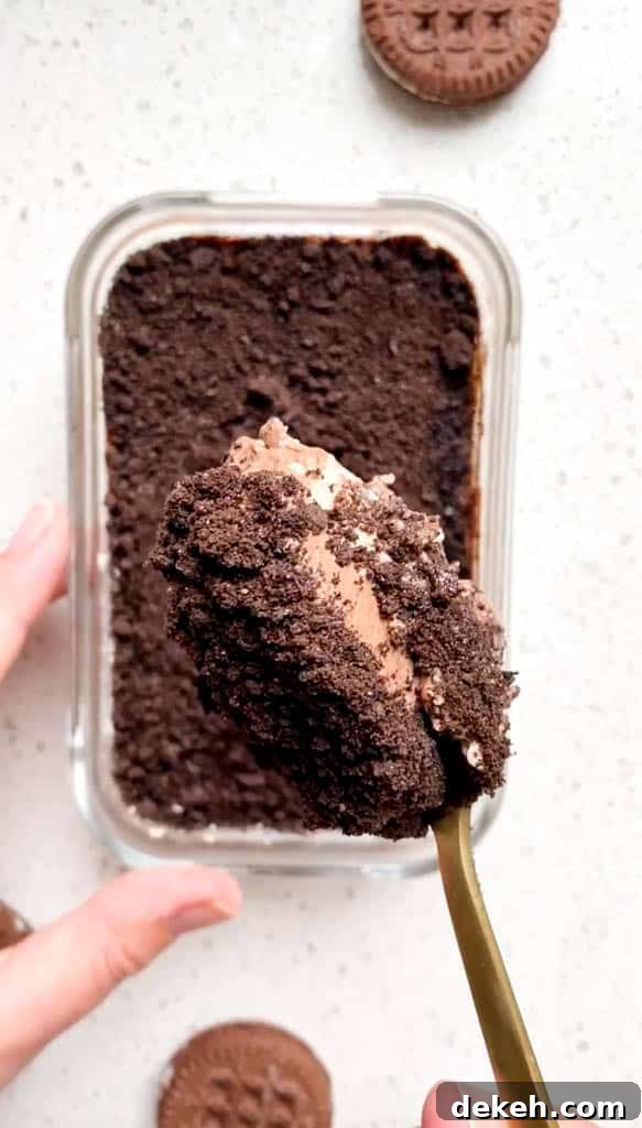 Oreo Protein Overnight Oats Recipe: High-Protein Breakfast 5 oreo overnight oats in glass container with spoonful in foreground with gold spoon