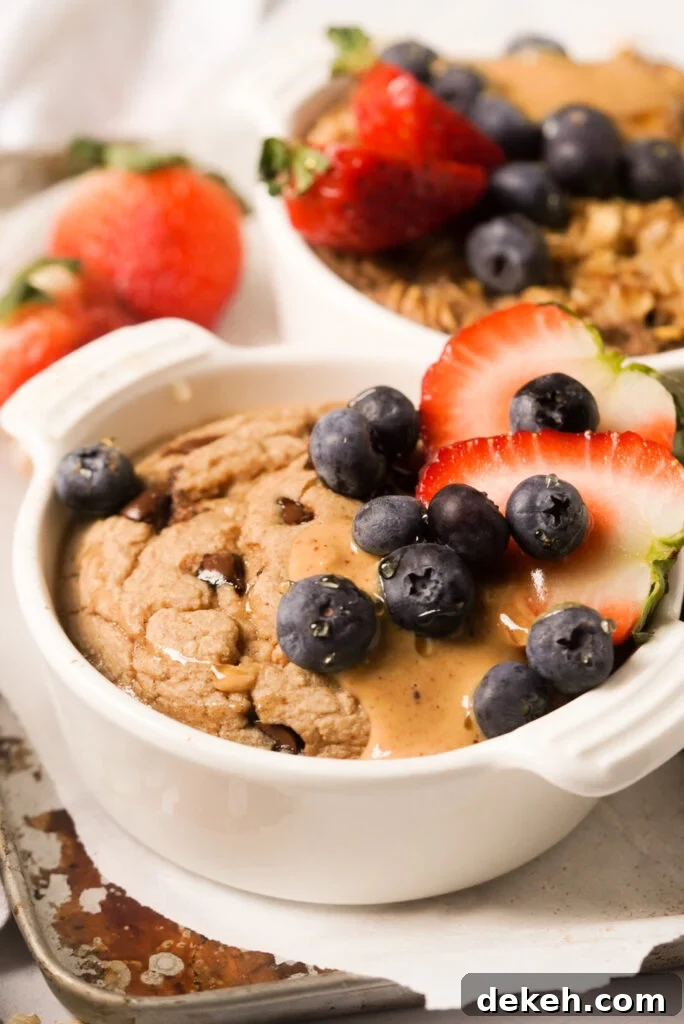 Single-Serve Baked Oats Without Banana 2 baked oats without banana topped with berries, peanut butter, and honey