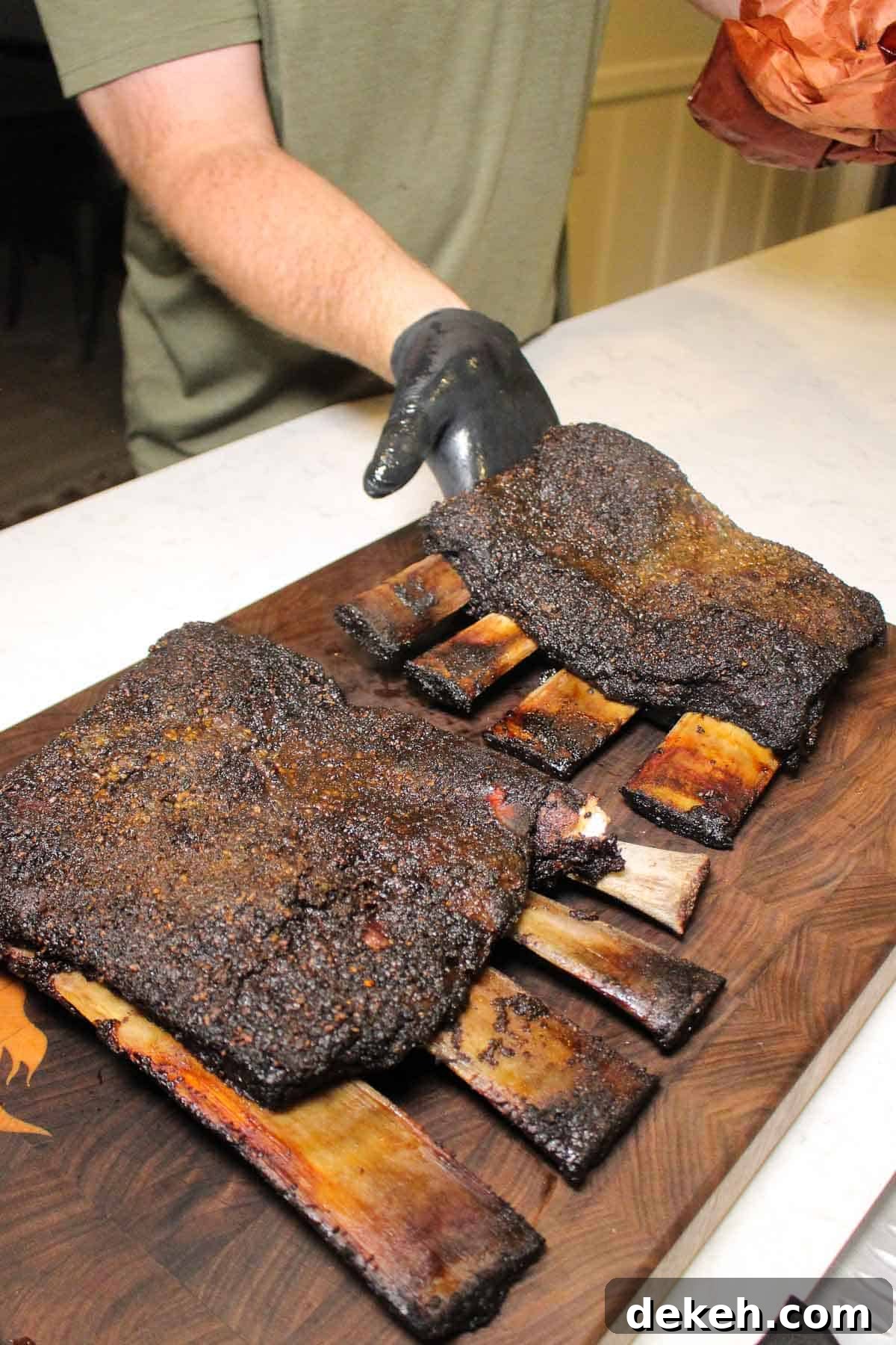 Smoked Beef Ribs with Garlic and Jalapeño 5 Placing both the racks of smoked garlic jalapeno beef ribs on the cutting board.