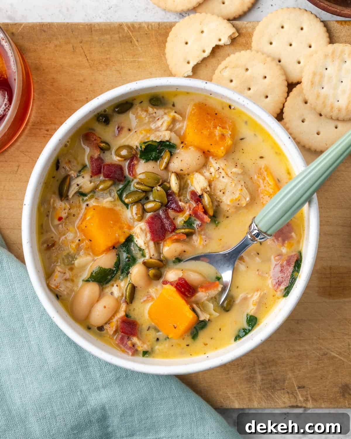 Creamy Chicken and Butternut Squash Soup Recipe 12 A bowl of chicken butternut squash soup served with crackers.