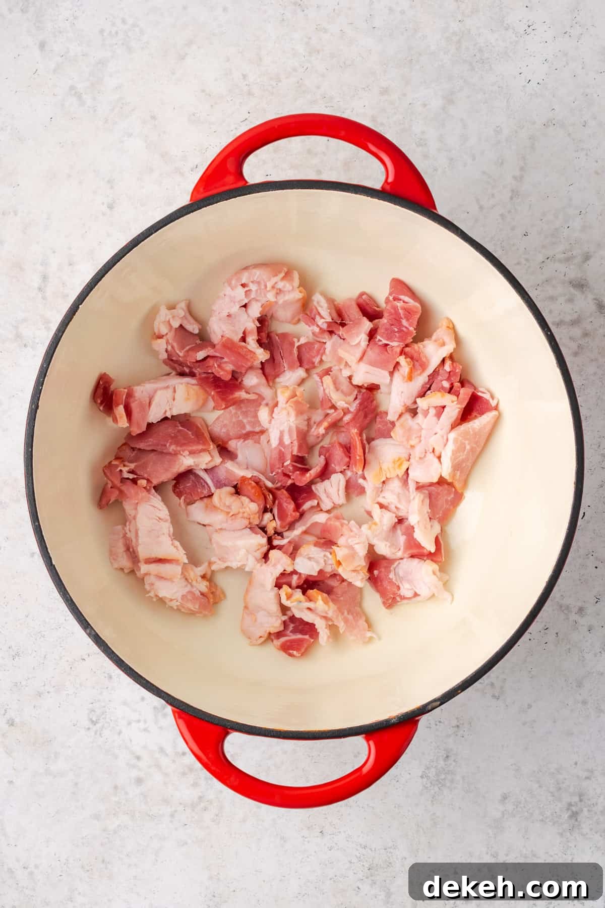 Creamy Chicken and Butternut Squash Soup Recipe 4 Bacon cooking in a large dutch oven pot.