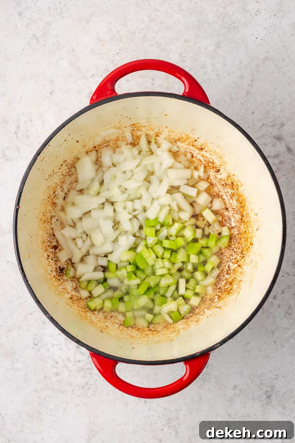 Creamy Chicken and Butternut Squash Soup Recipe 5 Diced onion and celery cooking in a soup pot.