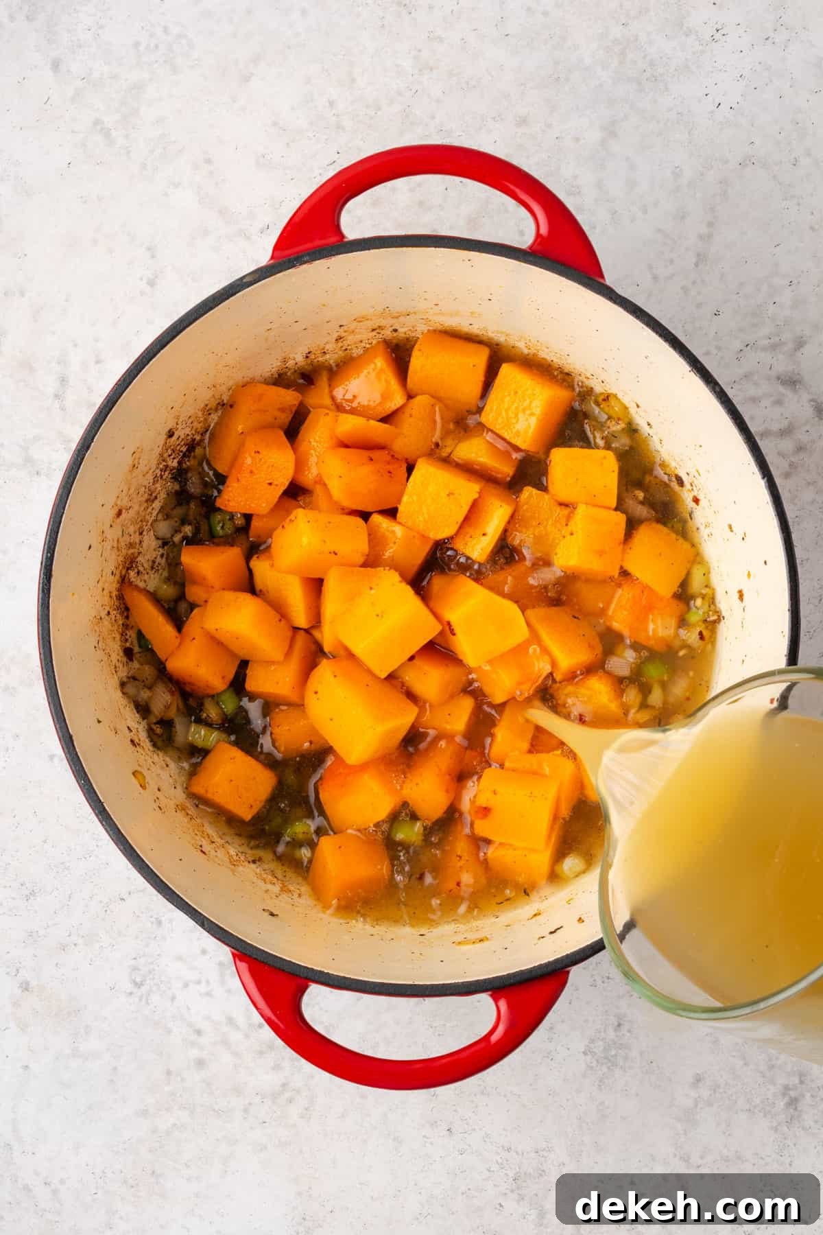 Creamy Chicken and Butternut Squash Soup Recipe 7 Squash and chicken broth added to the dutch oven pot.