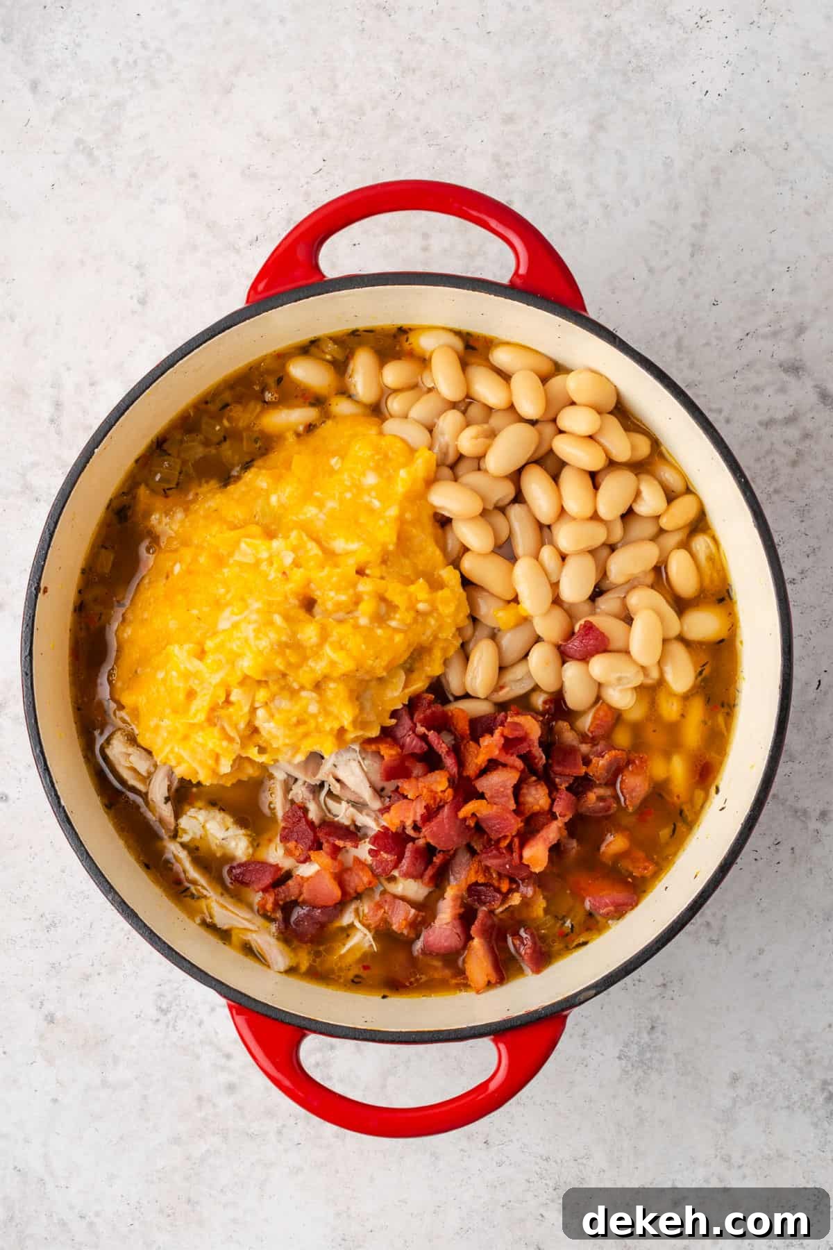 Creamy Chicken and Butternut Squash Soup Recipe 9 Chicken, mashed squash, beans and bacon added to the soup pot.