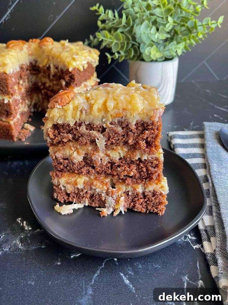 Original Baker's German Chocolate Cake Recipe 3 A slice of original Baker's German chocolate cake on a black plate.