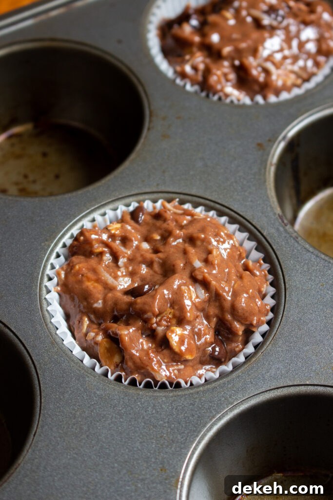 Moist Coconut Oatmeal Chocolate Muffins 4 Scooped muffin batter in tin