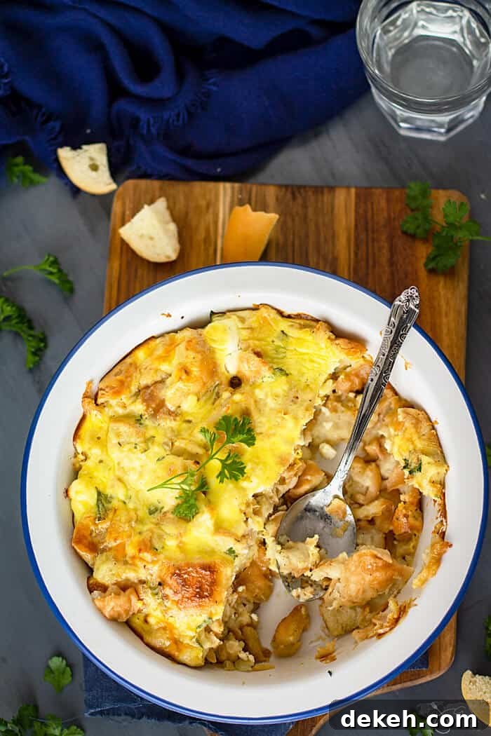 Caramelized Onion and Feta Bread Pudding 2 White baking dish with half-eaten bread pudding on a wooden cutting board