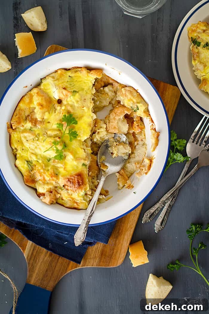 Caramelized Onion and Feta Bread Pudding 5 A dish of stale bread, feta cheese, and onions with a spoon resting in it.