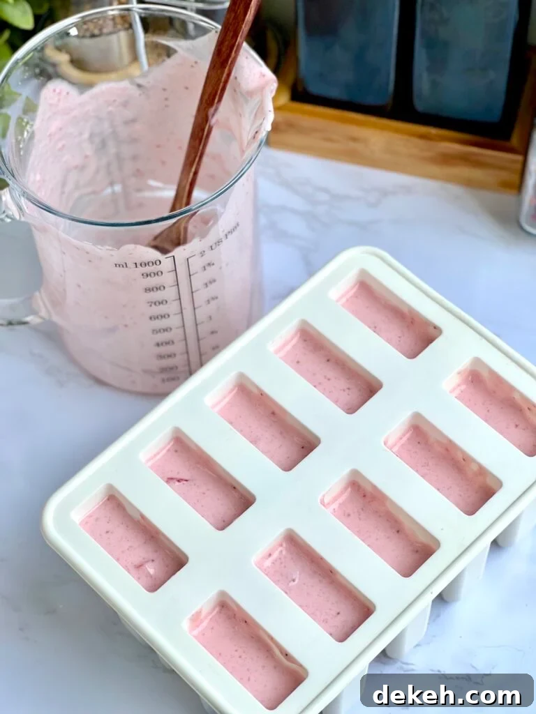 Creamy Strawberry Paletas: Homemade Mexican Ice Pops 4 Popsicle molds with strawberry mixture