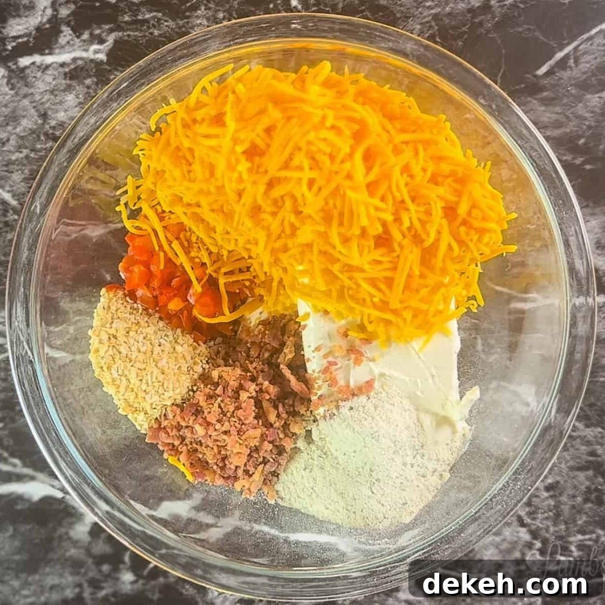 cheese ball ingredients in a glass bowl.
