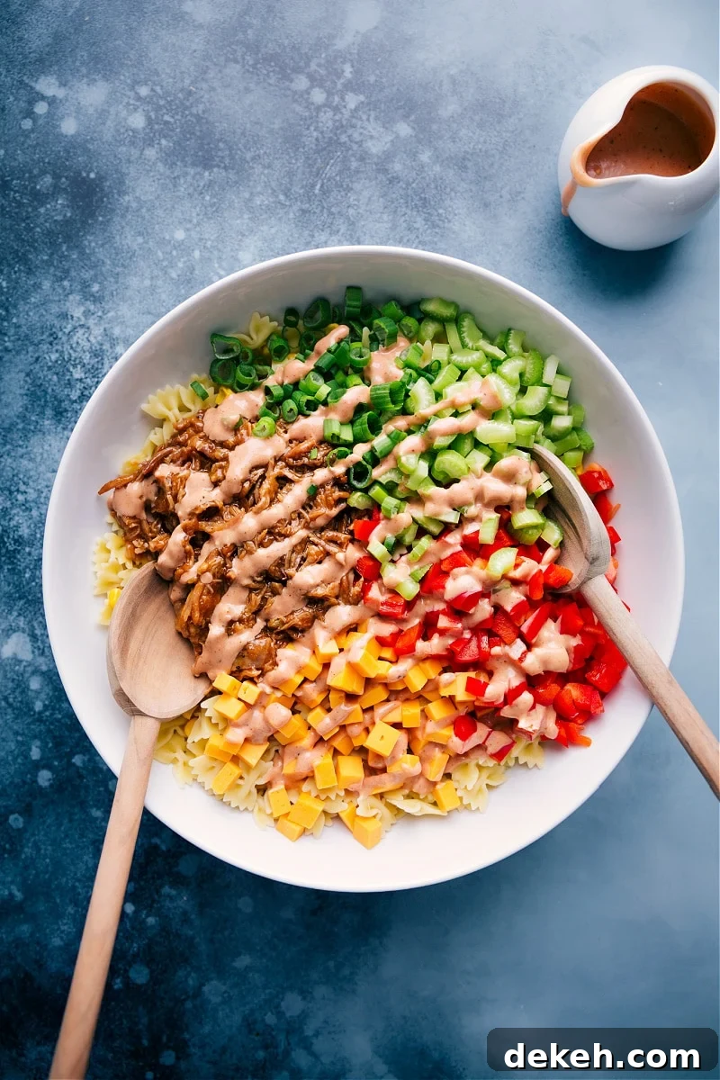 The Best BBQ Pasta Salad Recipe BBQ Pasta Salad in a large bowl drizzled with the creamy dressing.